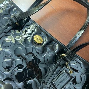 Black, shiny Coach bag